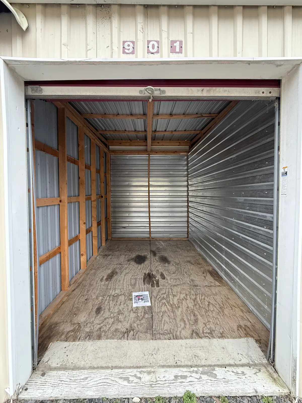 Interior of an 8x12 residential storage unit in Scranton with wooden frame structure, metal shelving, wooden floor, and open space for larger items and furniture